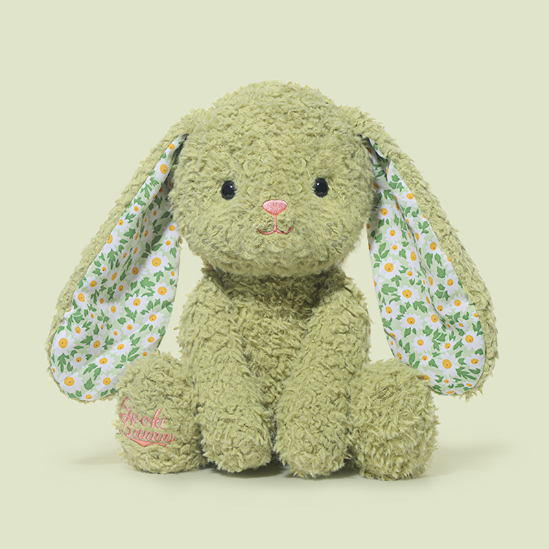 Petal-eared bunny plushie on a bed